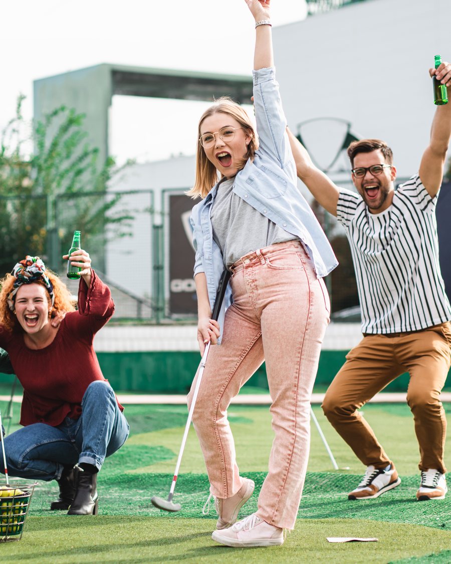 A team cheering and laughing during a golf game