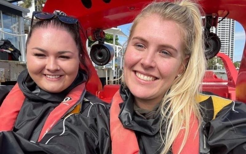 Two friends in life jackets grinning on a jet boat on a Sydney girls weekend