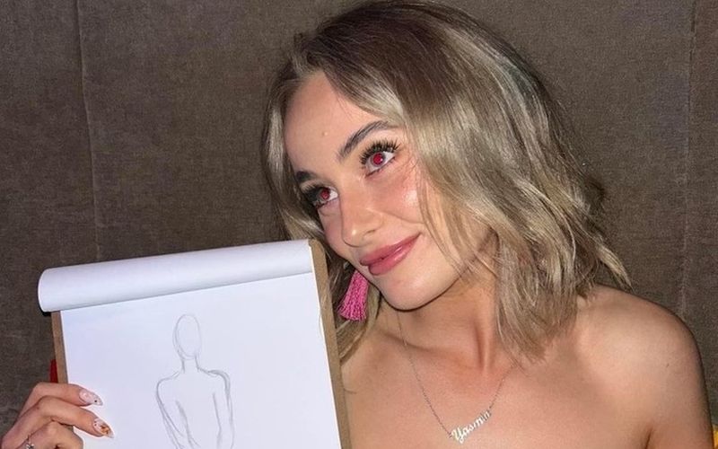 A friend proudly holding up her life drawing sketch on a Sydney girls weekend