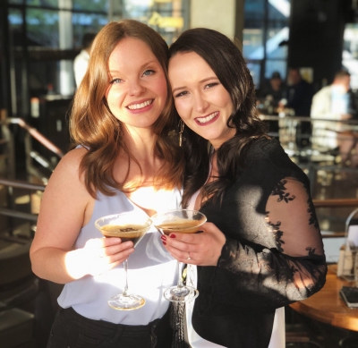 Photo sent in with this review: Two friends smiling with espresso martinis at a bar at night