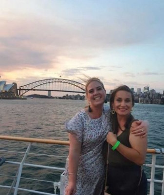 Photo sent in with this review: Two women on the deck of a harbour cruise at sunset, with the Harbour Bridge behind them