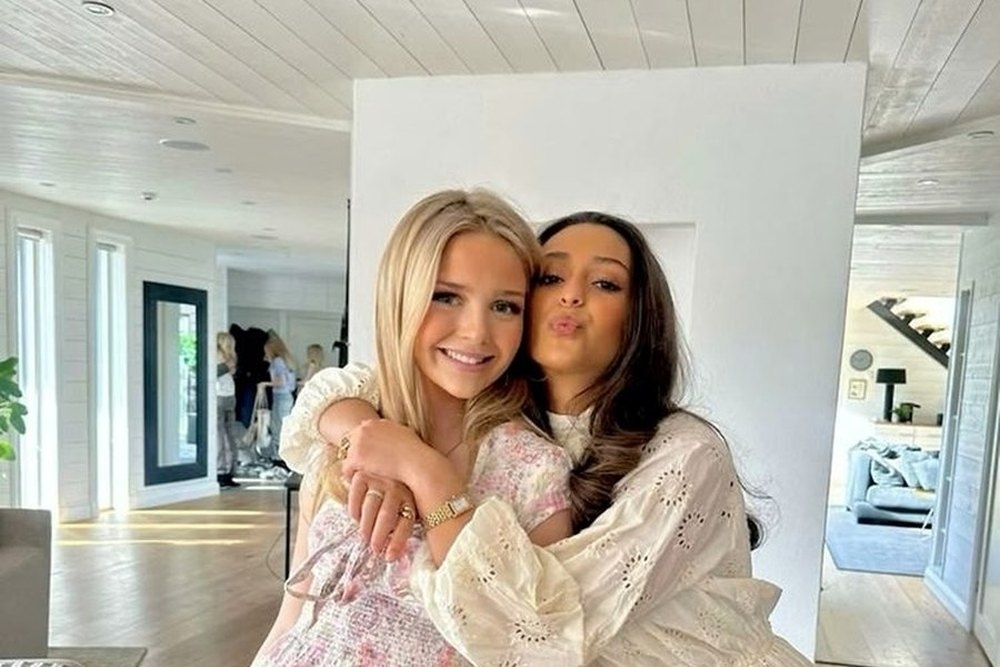 Two friends hugging and pouting in the bright apartment