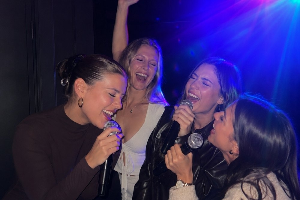 The girls singing their hearts out under the karaoke lights