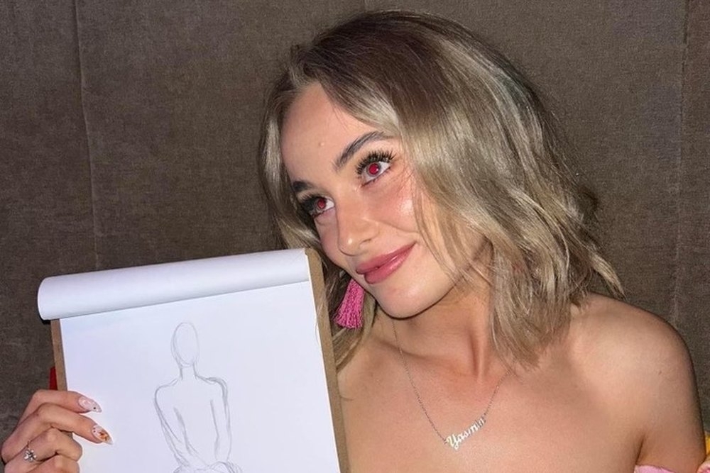 A friend proudly holding up her life drawing sketch