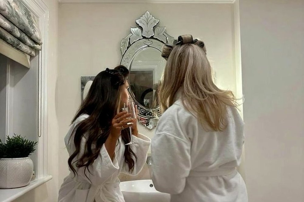 Friends in white robes getting ready together