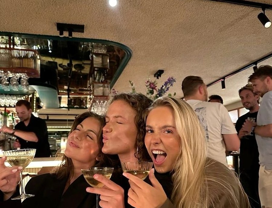 The girls pulling faces over drinks at a busy bar