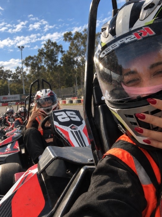 A helmeted selfie from the driver’s seat on the karting grid, with the girls lined up in karts behind